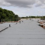 flat roof features a gray membrane surface