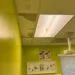 The ceiling tiles show significant water damage