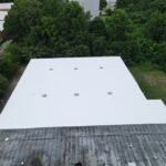 commercial building features a flat roof with a white coating