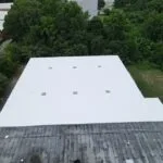 commercial building features a flat roof with a white coating