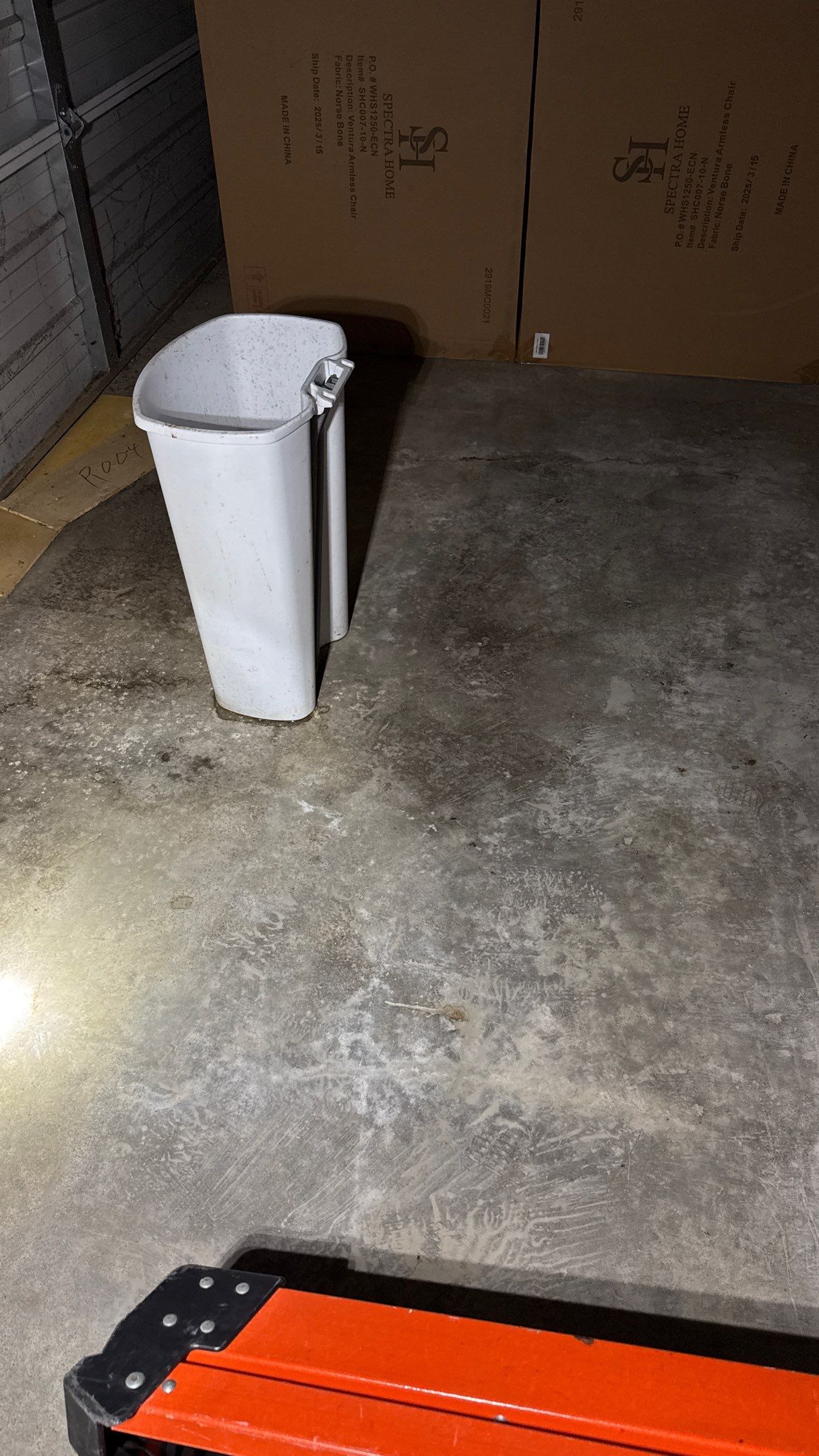 Trashcan positioned to catch active roof leak