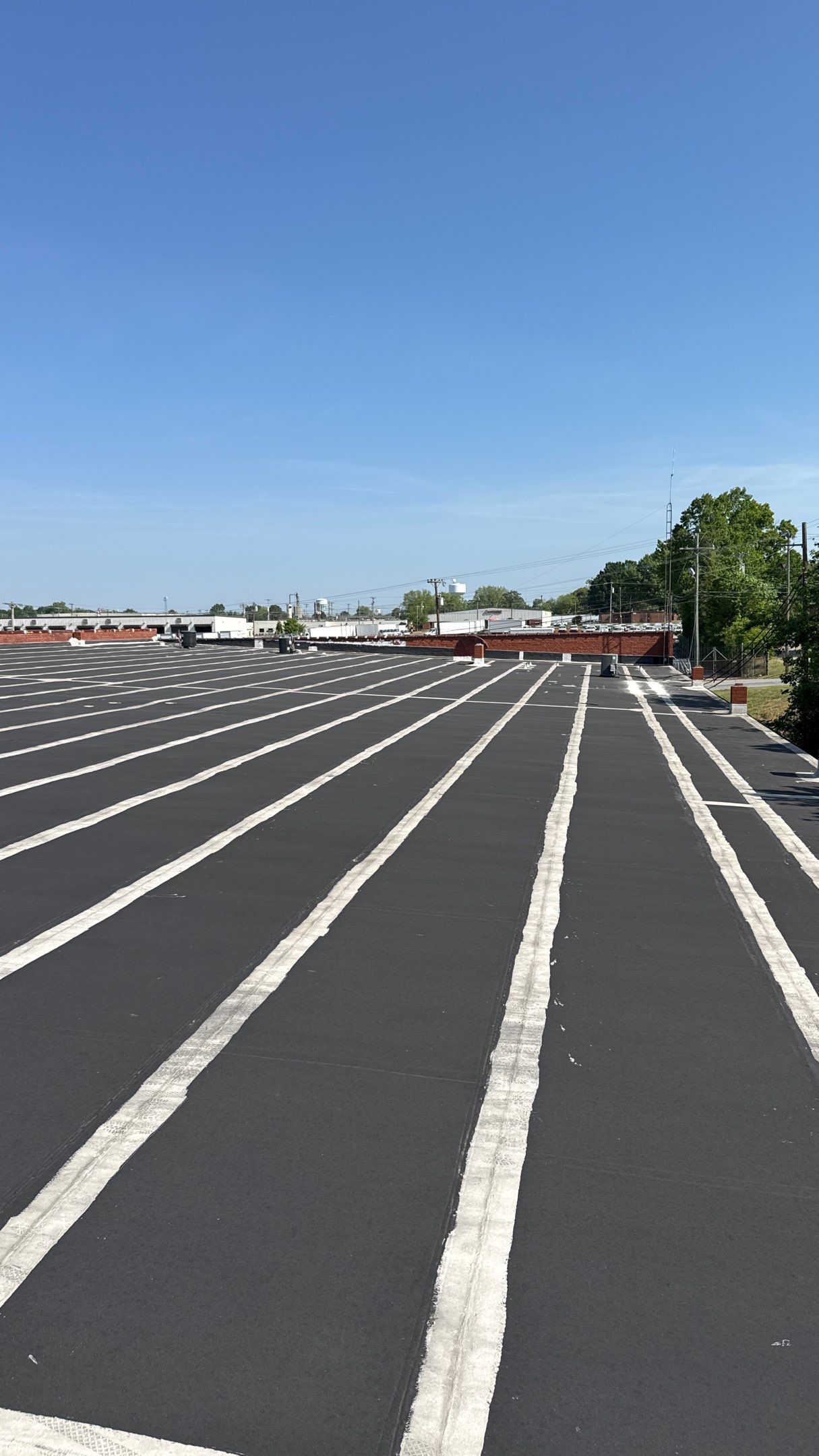 Commercial EPDM roof showing multiple patched seams