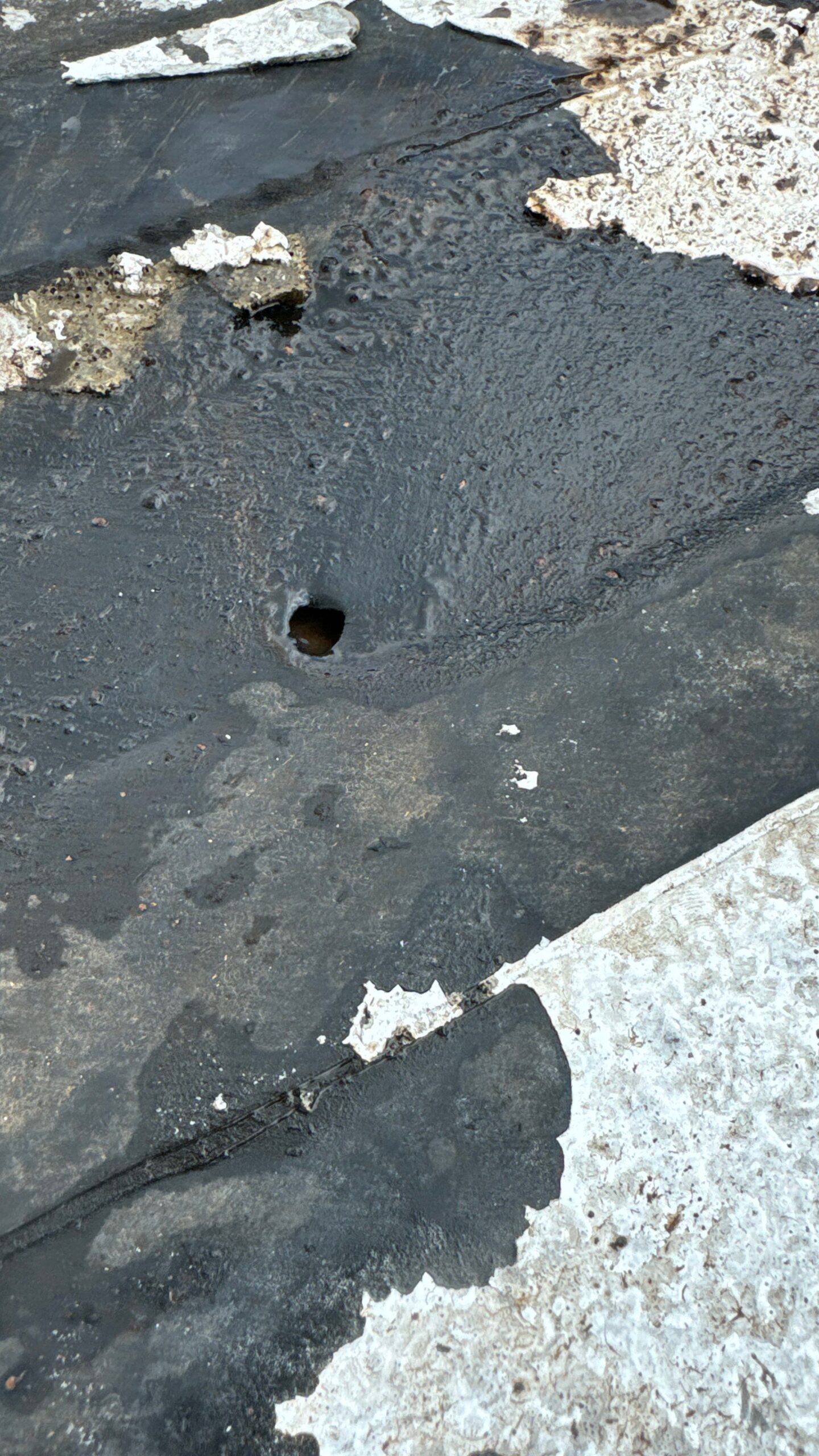 Screw penetration creating leak point in roof membrane