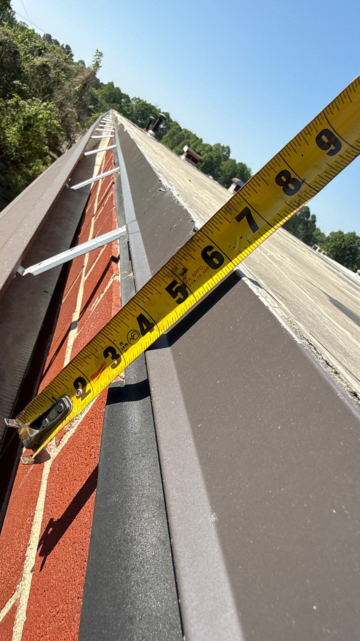 Damaged trim and loose gutter on commercial building