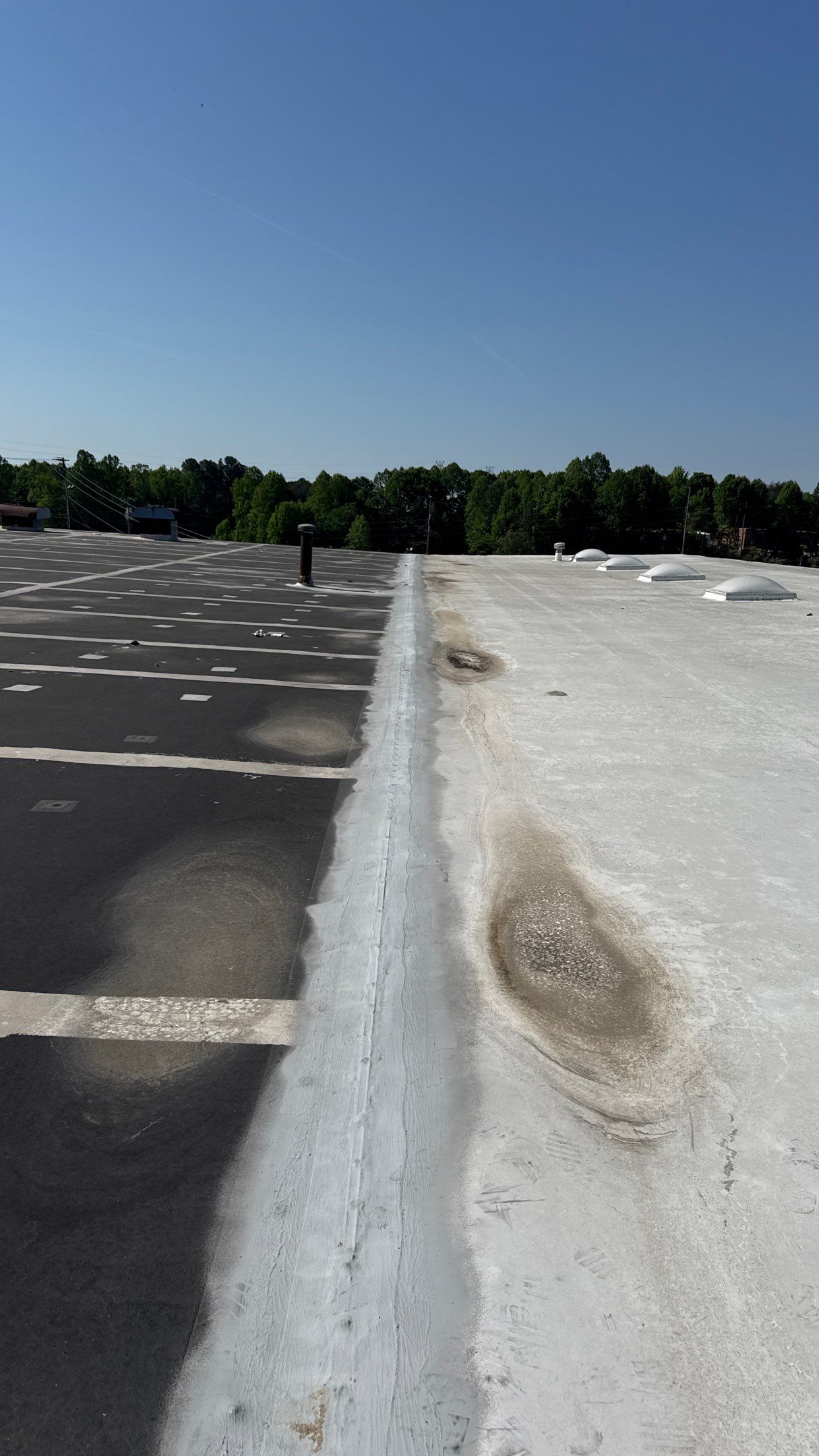 Ponding water stains on commercial flat roof