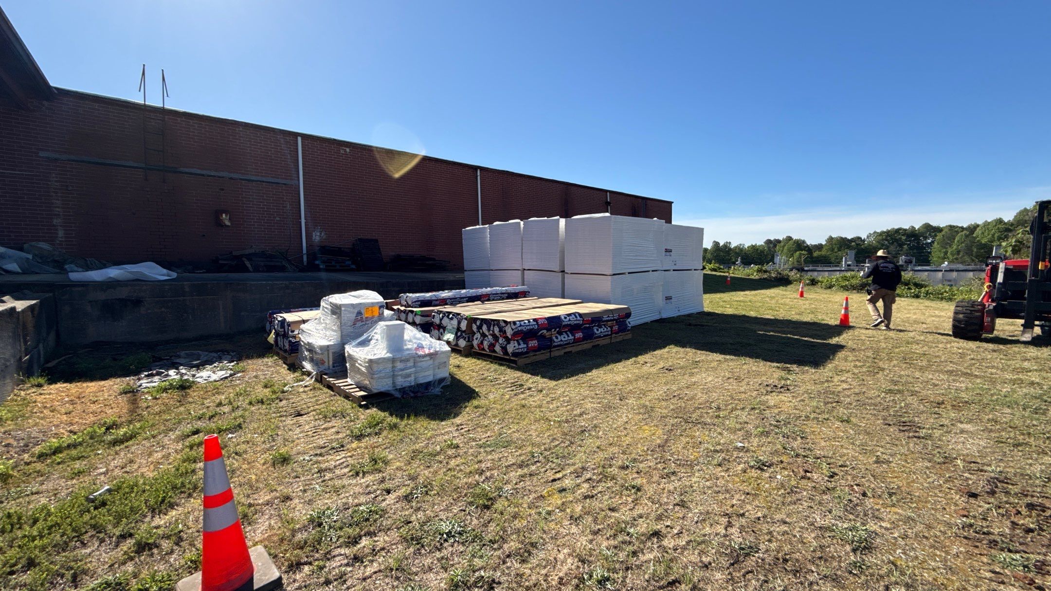 Roofing materials staged on commercial building site