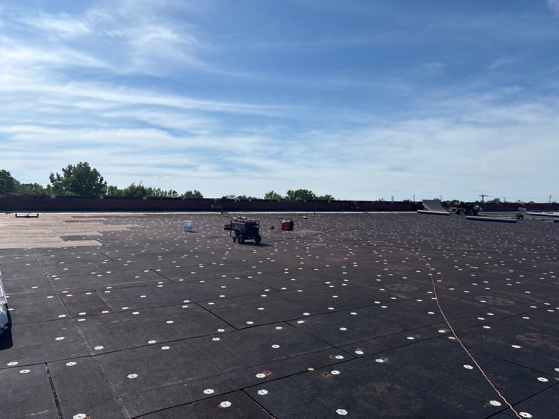EPDM membrane removed exposing fiber board insulation