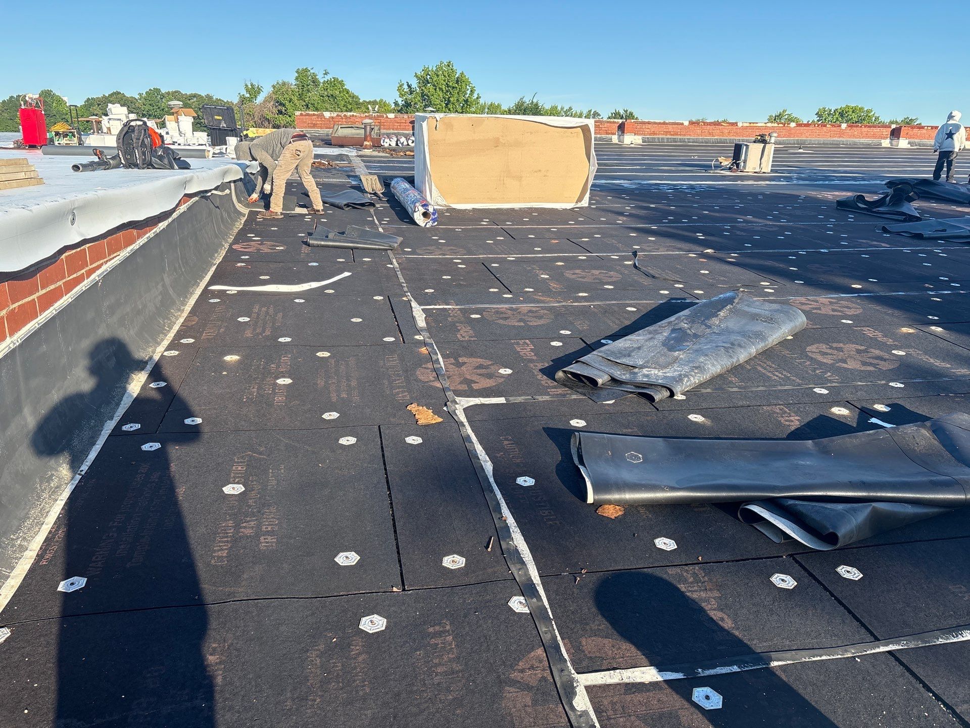Materials staged on partially torn off commercial roof