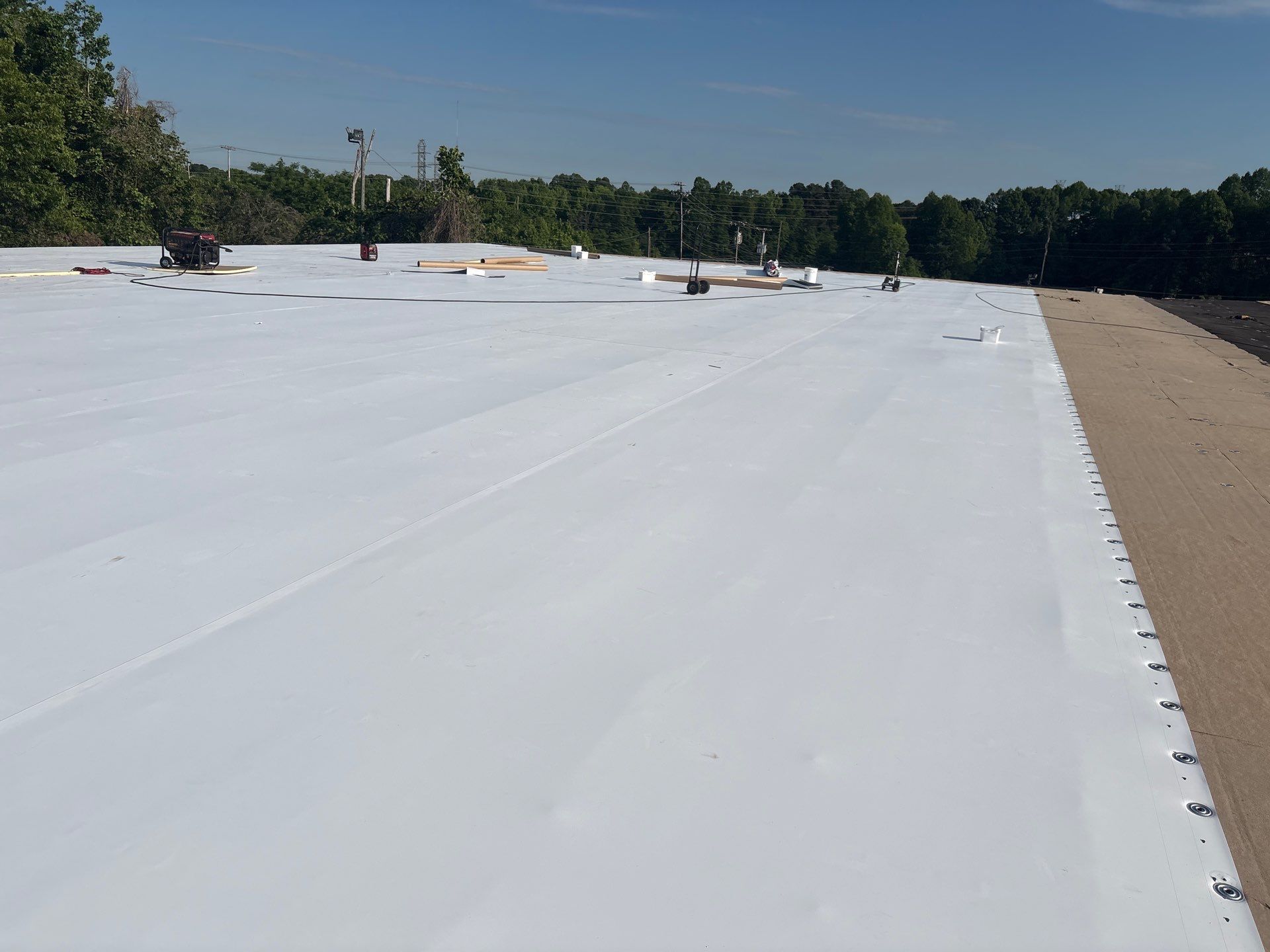 TPO membrane being installed on commercial roof