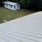 Technician performing commercial roofing on a commercial roof in Denton, NC