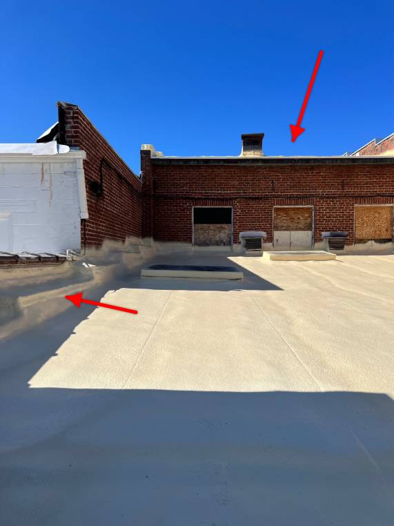 Technician performing spray foam on a commercial roof in Trinity, NC