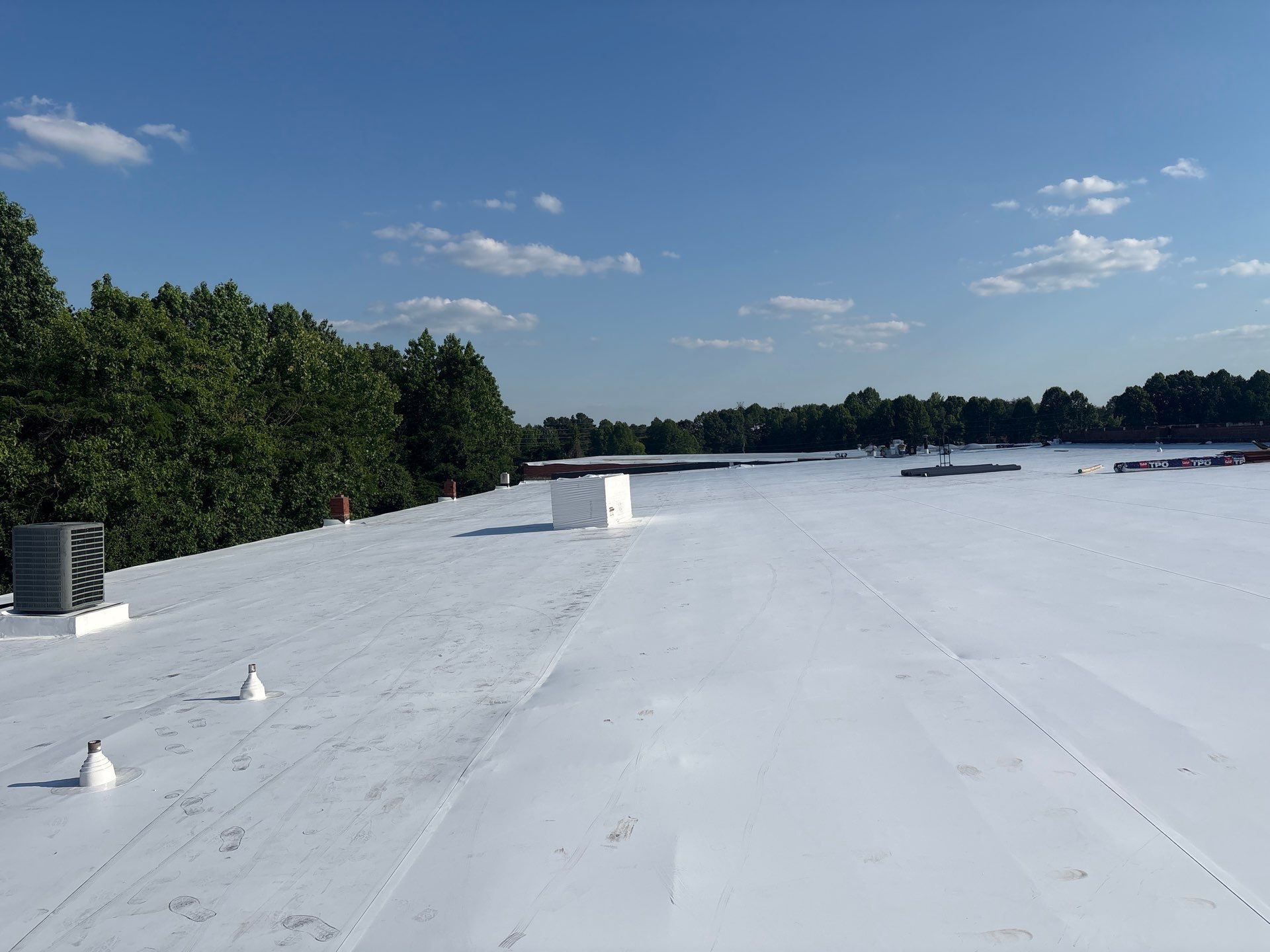 Technician performing tpo roofing on a commercial roof in High Point, NC