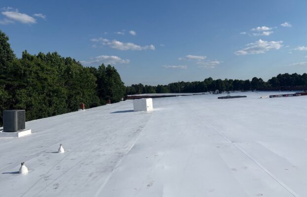 Technician performing tpo roofing on a commercial roof in High Point, NC