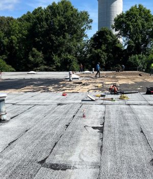 commercial roofing contractors working on a flat roof
