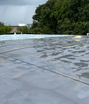 flat commercial roof undergoing a coating process